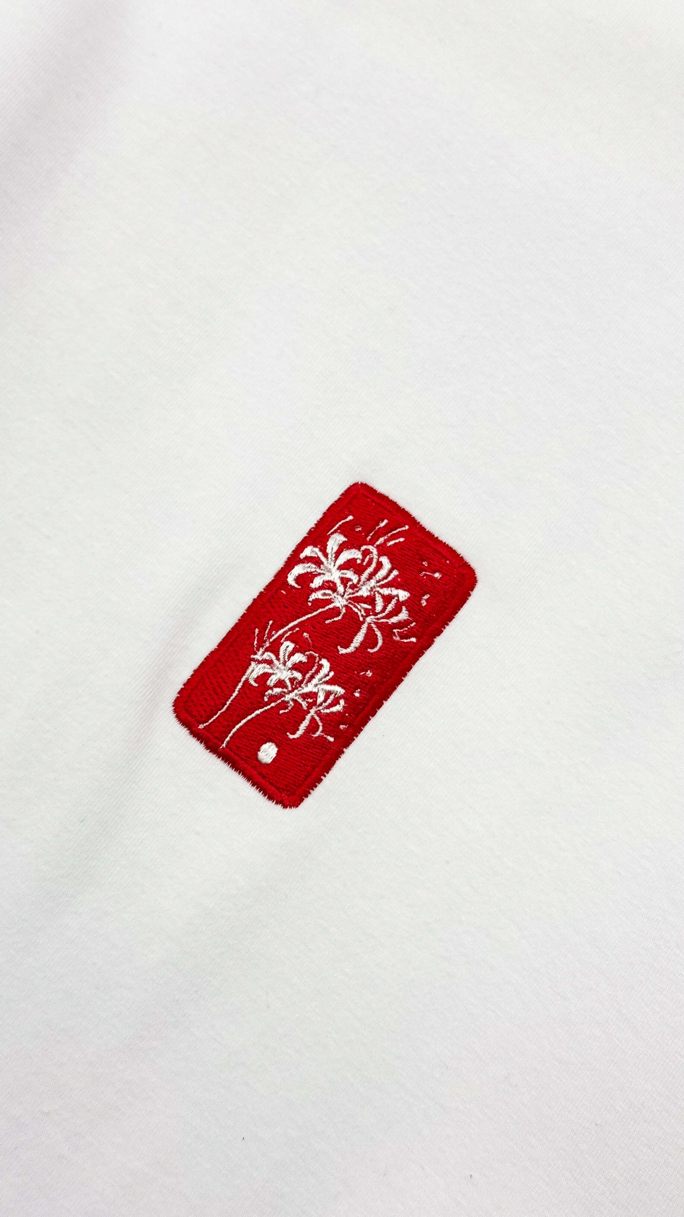 Spider Lily - White Cropped Oversized Tee with red embroidered logo detail on a white fabric.