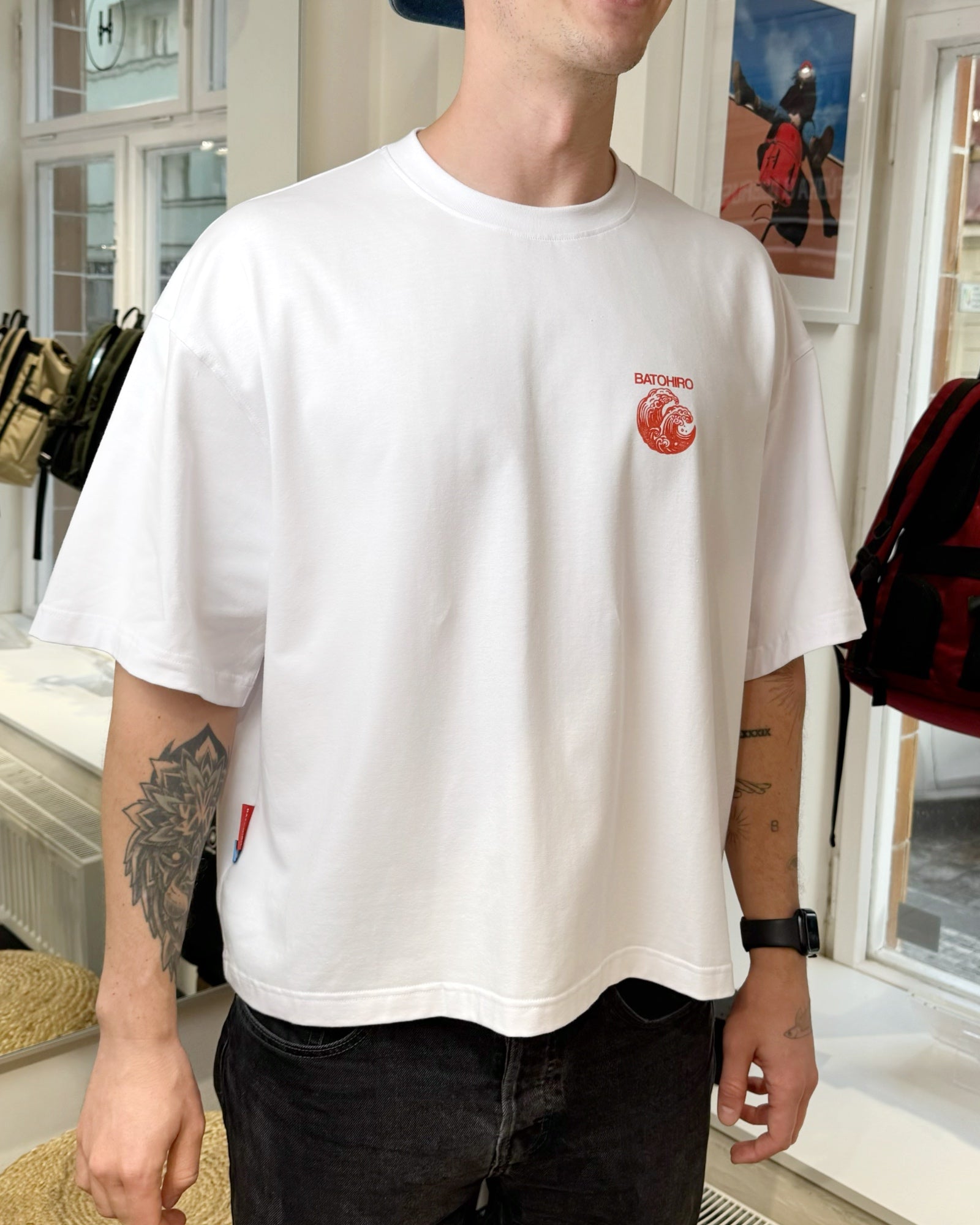 "Hiro Wave cropped oversized tee in white, featuring original Batohiro design, modeled in a retail setting."