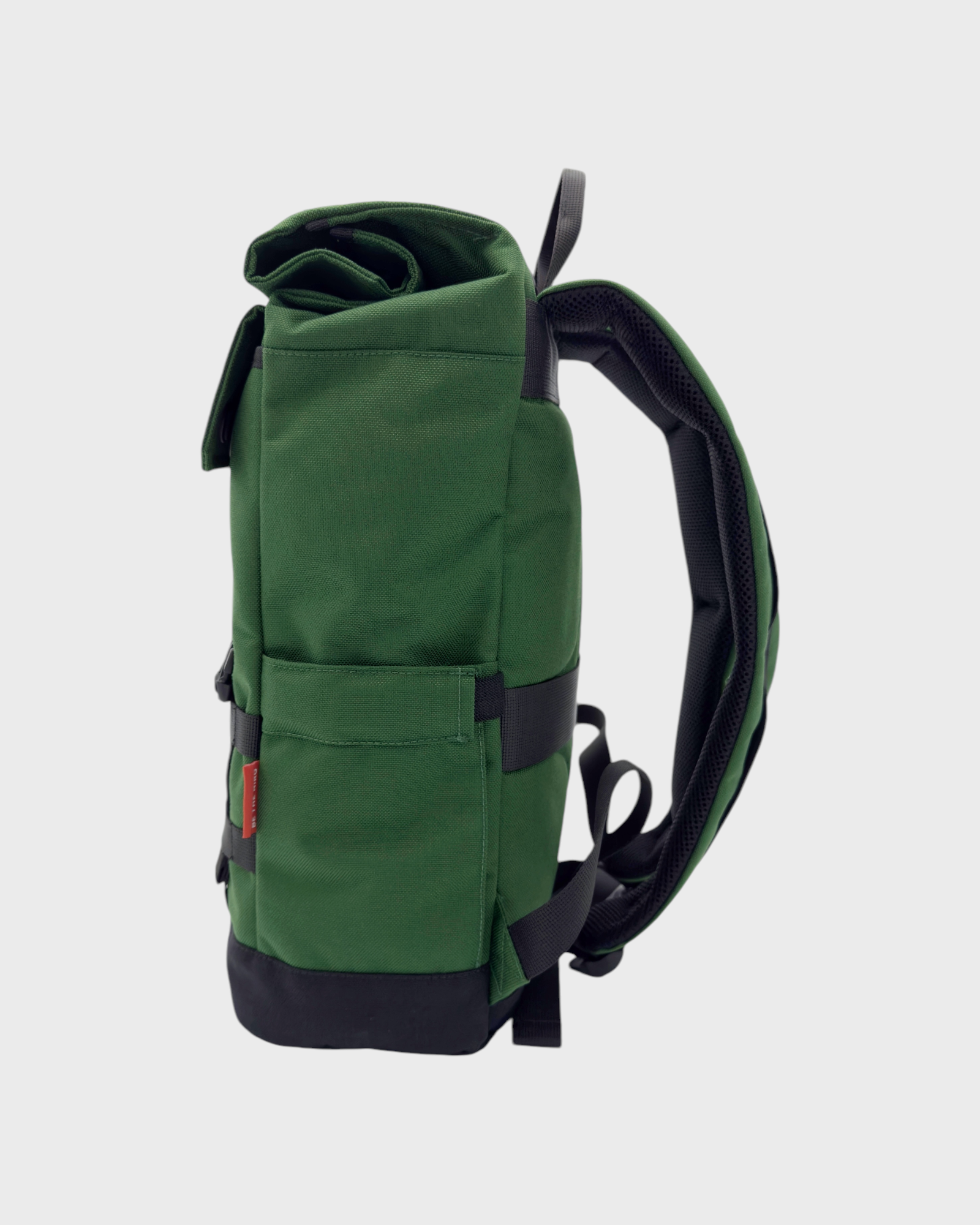 Forest Green Minato Lite backpack side view, showcasing compact and flexible design with adjustable size features.